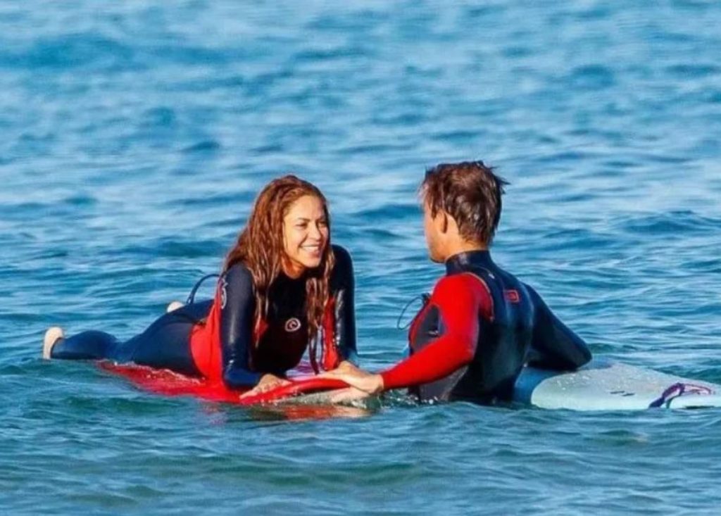 Shakira with her surf instructor